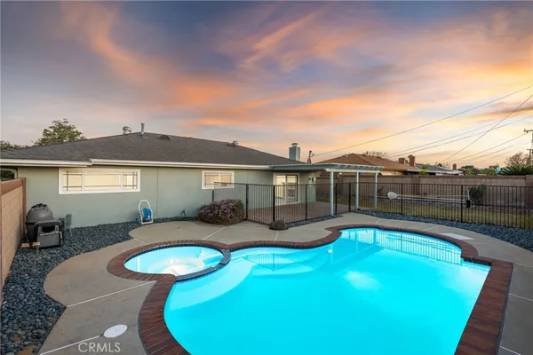 a view of a swimming pool with furniture