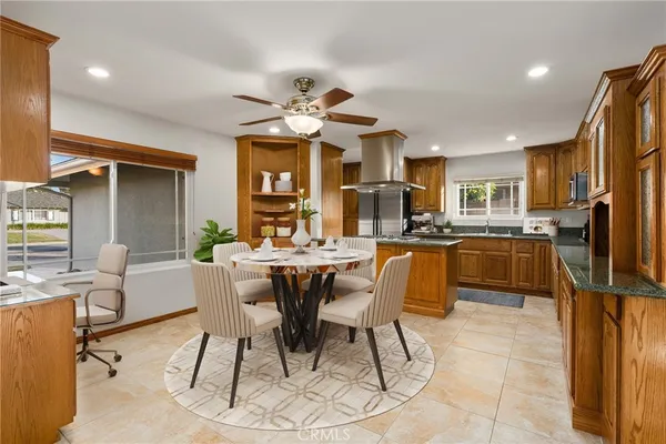 a view of a dining room with furniture and a kitchen