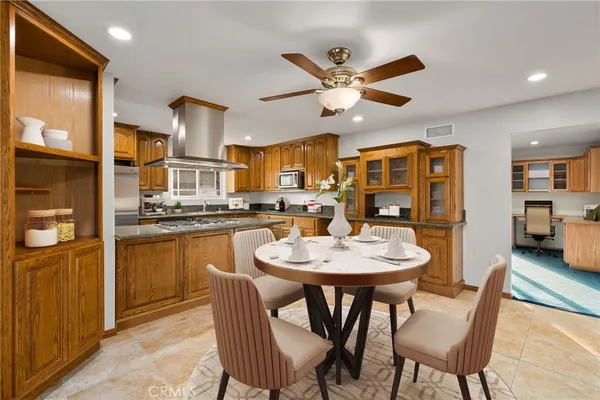 a kitchen with stainless steel appliances granite countertop a sink stove and cabinets