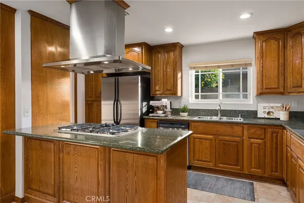 a kitchen with stainless steel appliances granite countertop a stove and a sink