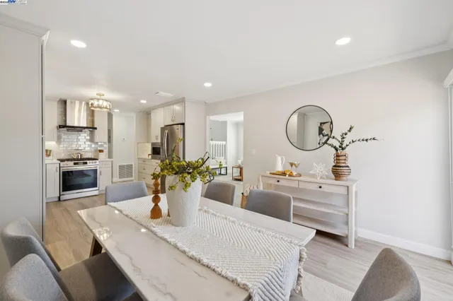 a large kitchen with a table and chairs