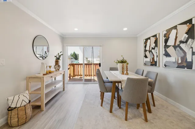a dining room with furniture and wooden floor