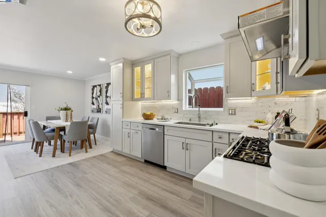 a large kitchen with a table and chairs