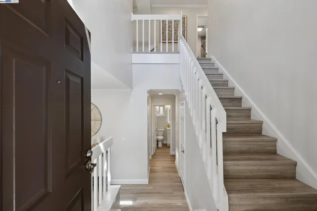 a view of a hallway with wooden floor and entryway