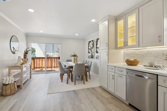 a view of a kitchen area with furniture and wooden floor