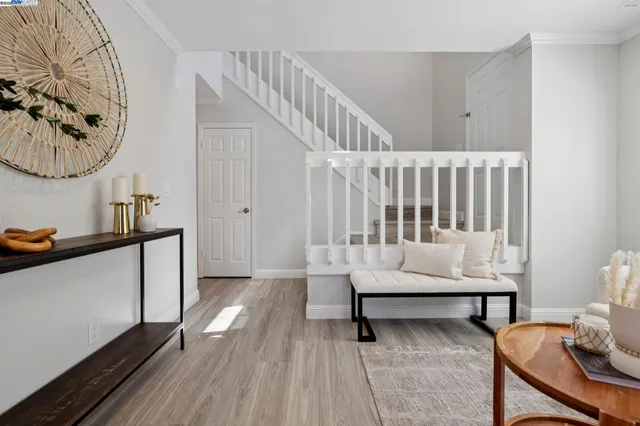 a view of entryway and hall with wooden floor