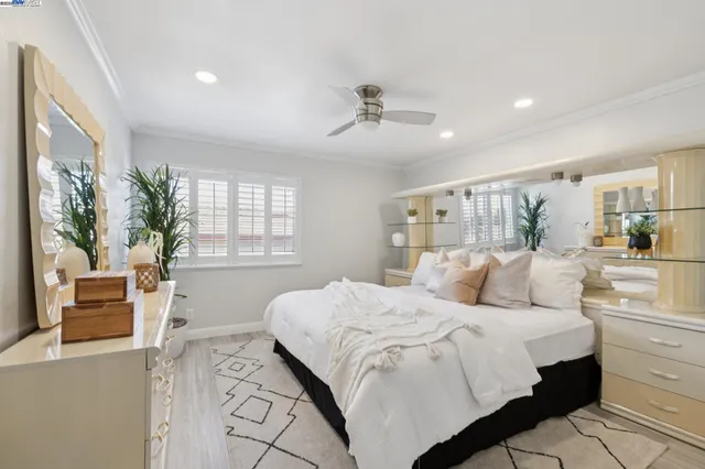 a bedroom with a large bed and a large window
