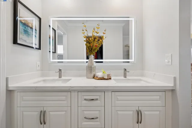 a living room with furniture and a painting on the wall