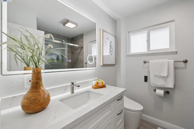 a bed room with a bed and a mirror