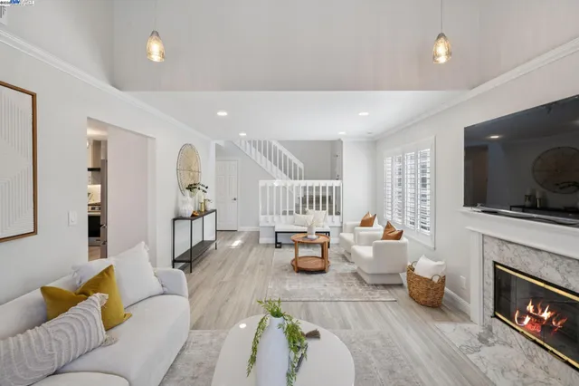 a living room with furniture and a fireplace