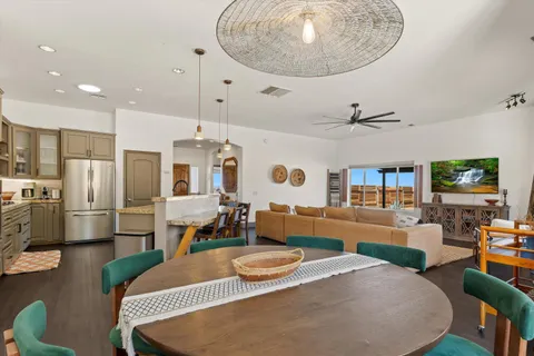 a large kitchen with kitchen island a dining table chairs and wooden floor