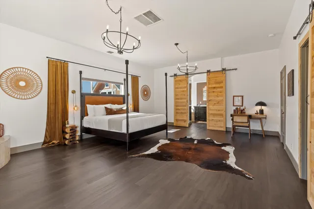 a bathroom with a granite countertop sink a large mirror and a bathtub