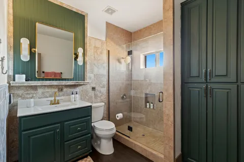 a bedroom with a bed and a mirror