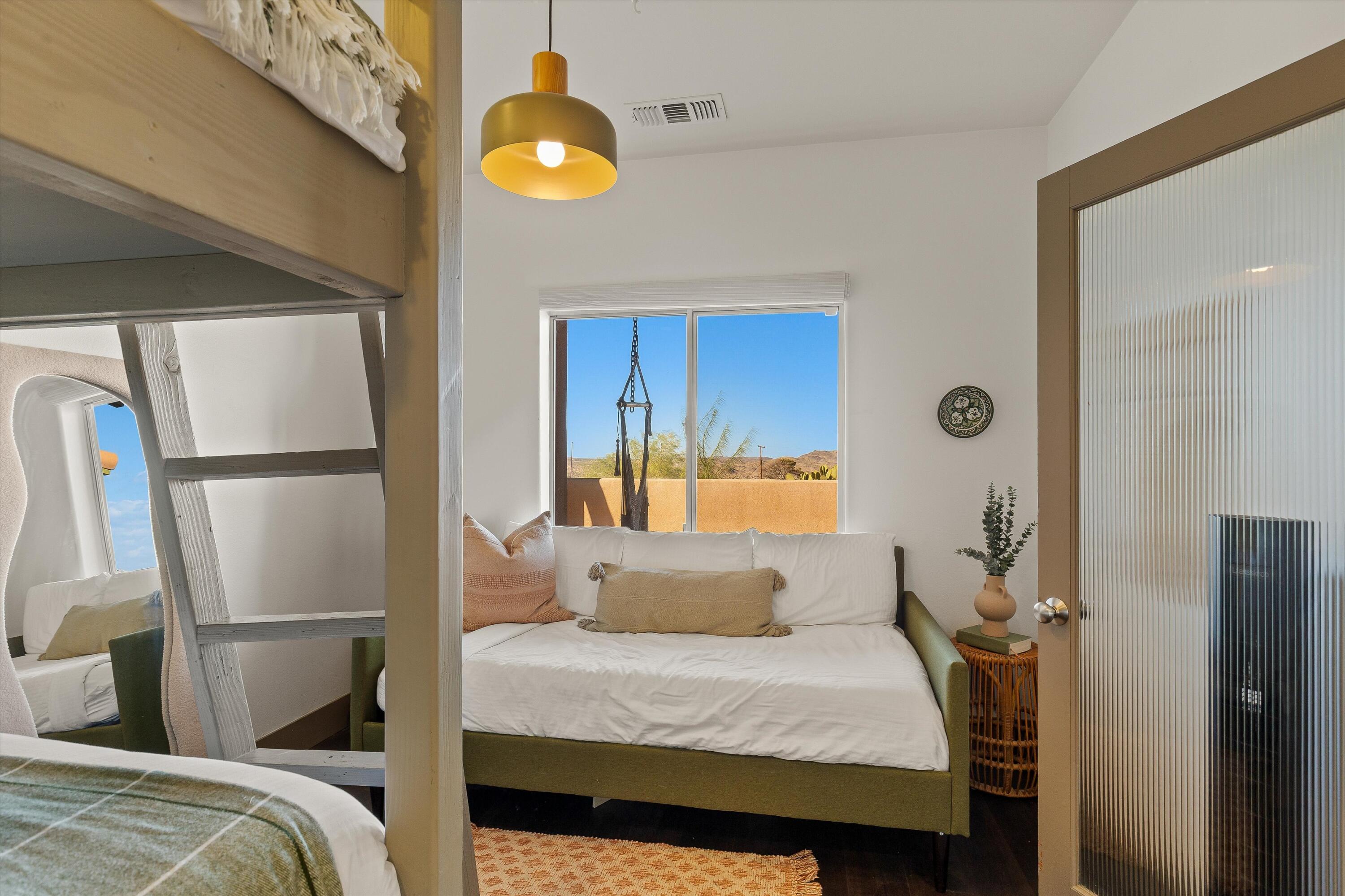 60377 Pueblo Trail Joshua Tree, CA 92252 - Photo 29 of 57 a bedroom with a bed and painting on the wall