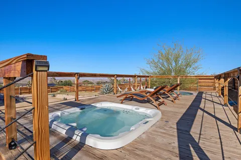 a kitchen with stainless steel appliances granite countertop a refrigerator a sink a stove a dining table and chairs