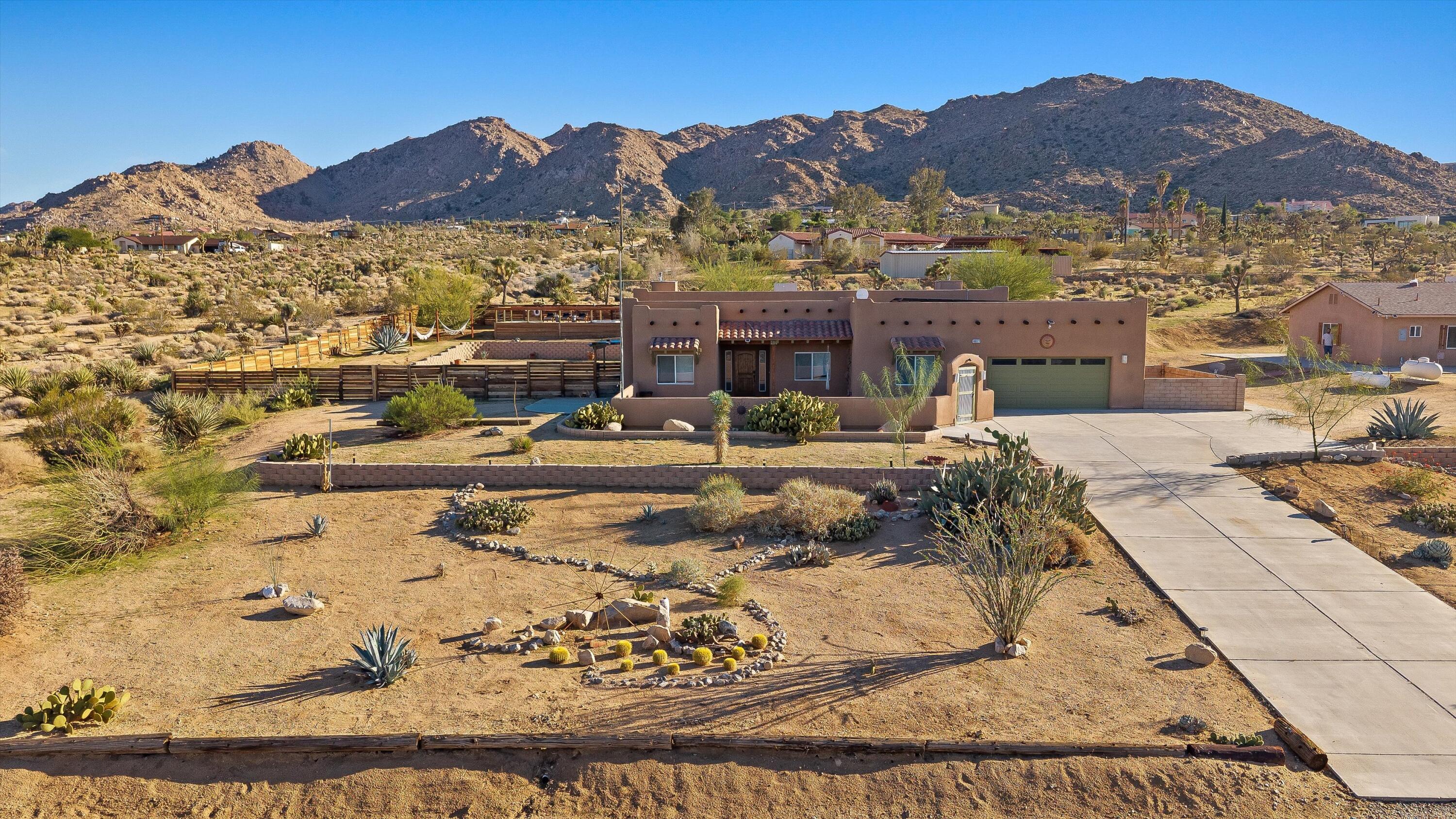 60377 Pueblo Trail Joshua Tree, CA 92252 - Photo 40 of 57 a view of a house with a mountain