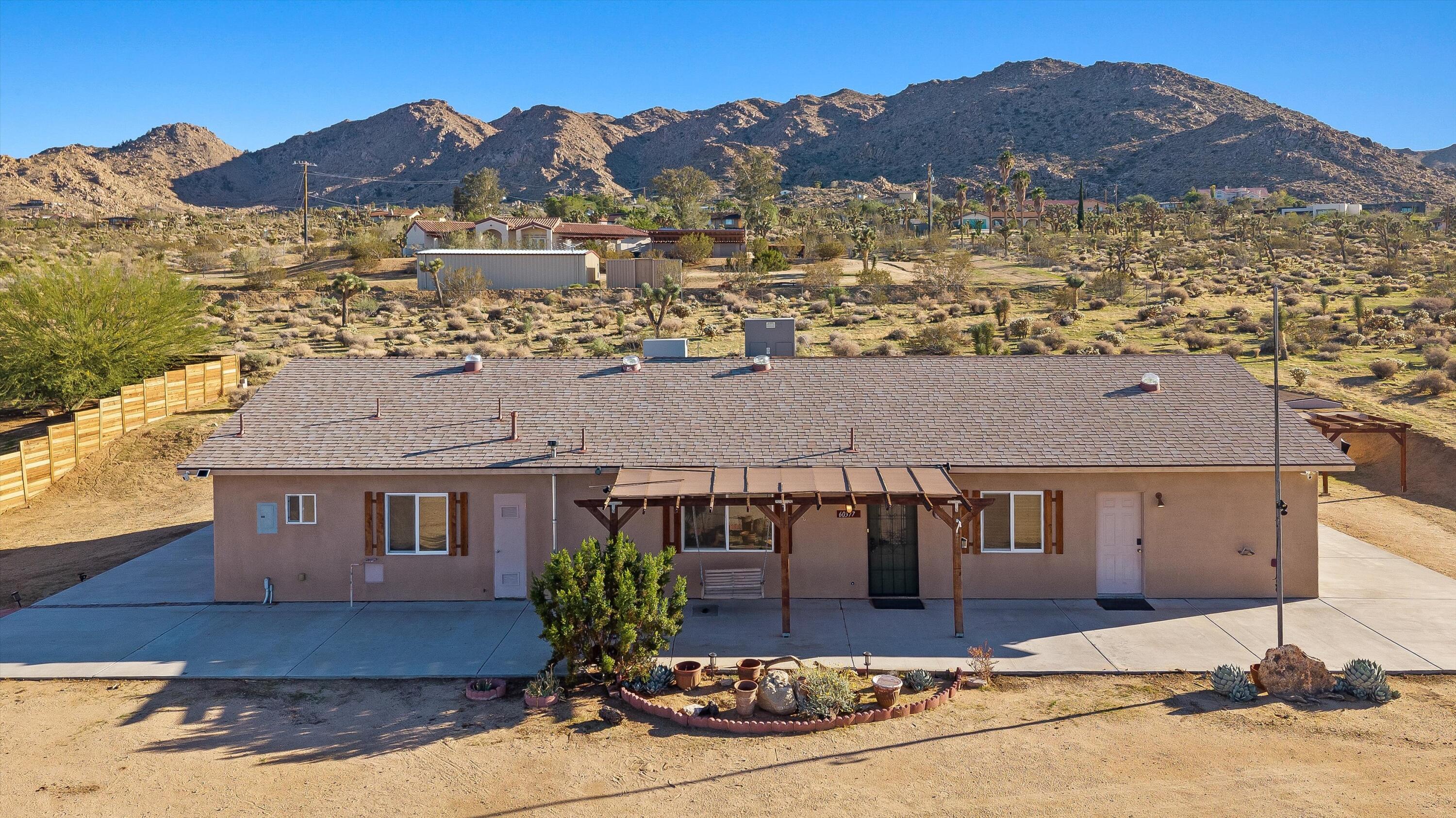 60377 Pueblo Trail Joshua Tree, CA 92252 - Photo 43 of 57 a front view of a house with a yard