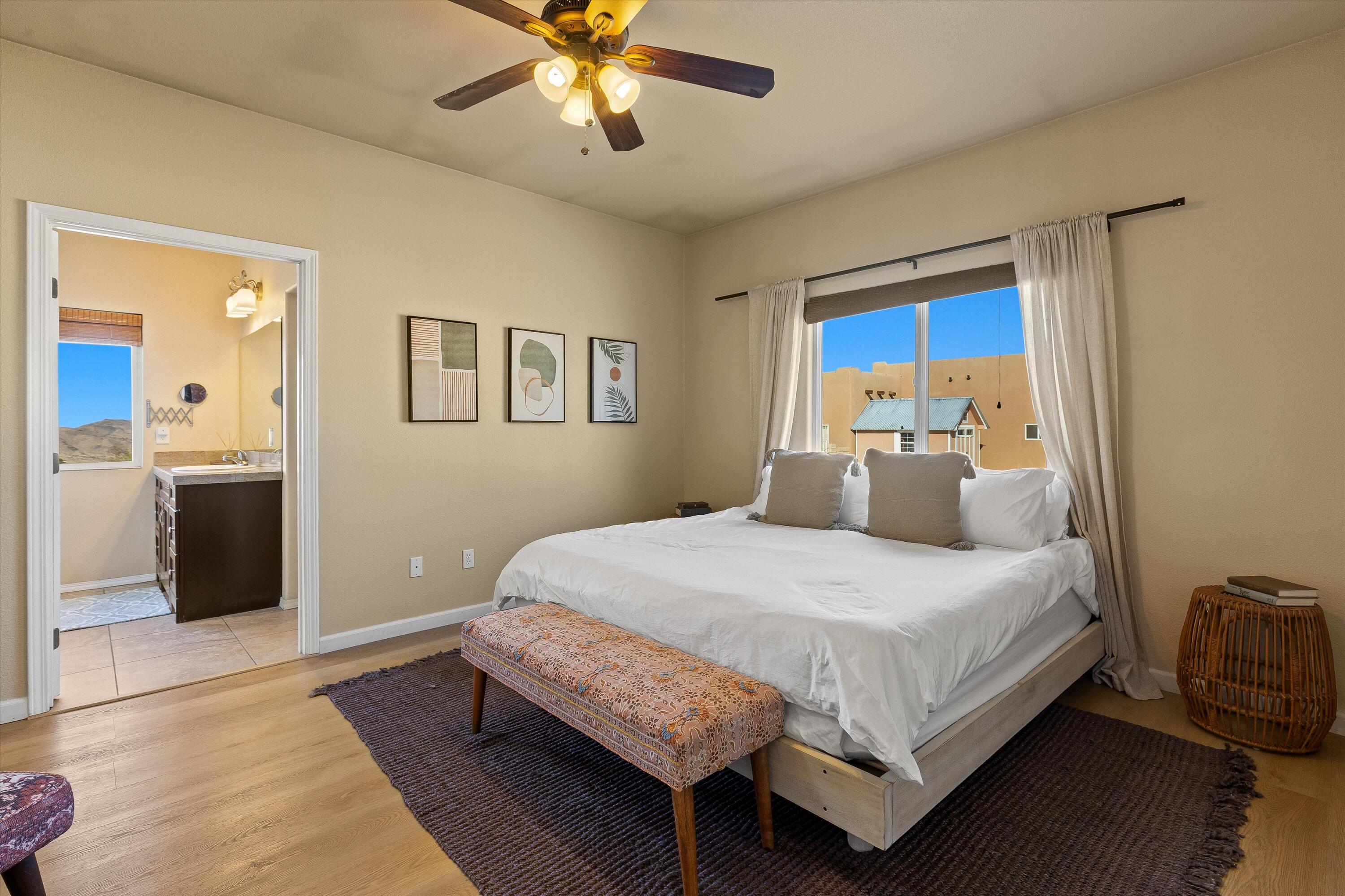 60377 Pueblo Trail Joshua Tree, CA 92252 - Photo 48 of 57 a bedroom with a bed and a chandelier