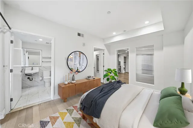 a bed room with a bed mirror and a table