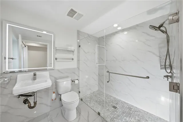 a bathroom with a toilet sink and a shower