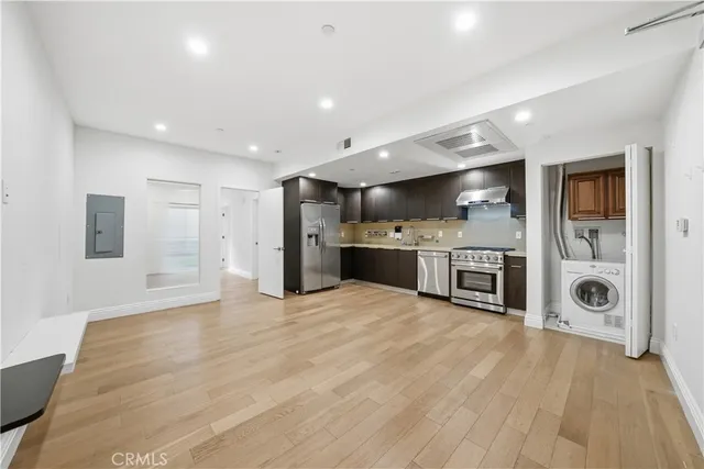 a view of a kitchen with a stove cabinets and wooden floor