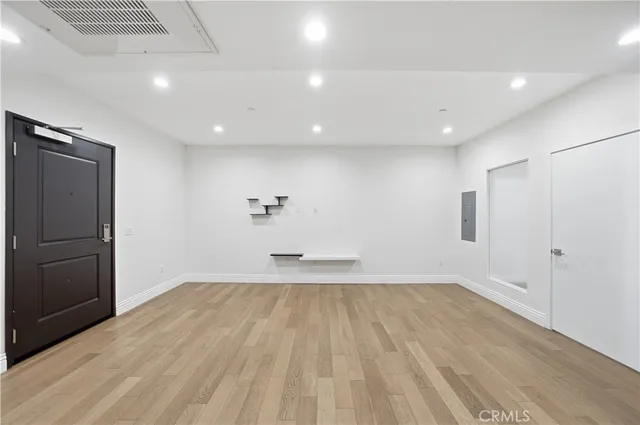 a view of empty room with wooden floor