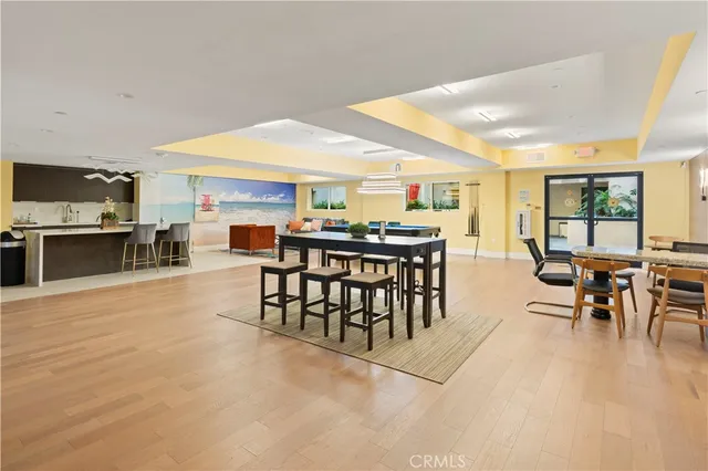 a dining area with furniture a kitchen view and a window