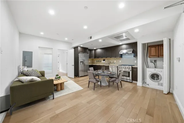 a living room with furniture and kitchen view