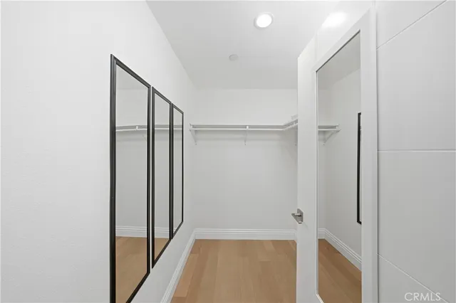 a view of a hallway with wooden floor and entryway