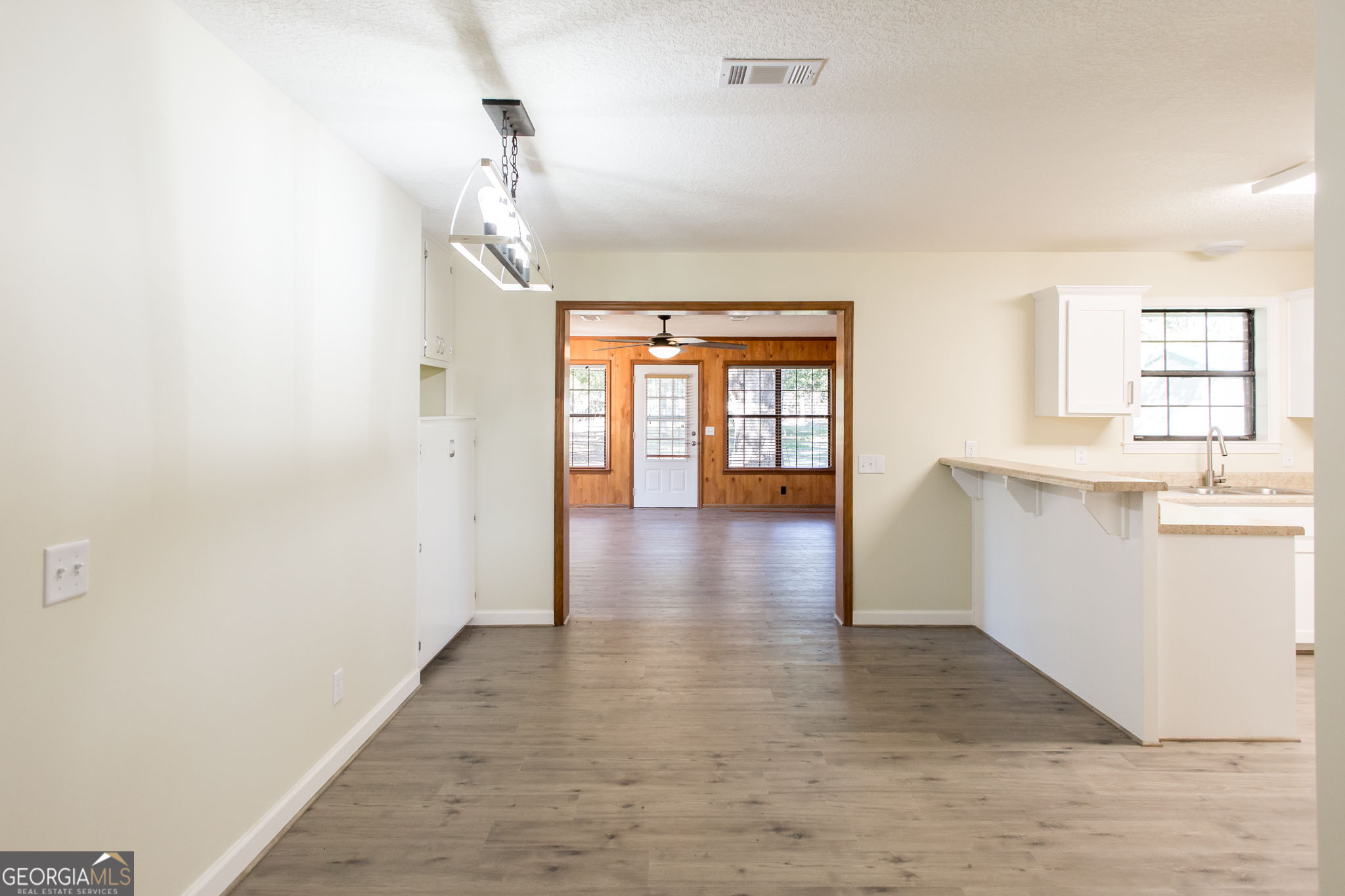 6731 Youmans Chapel Road Blackshear, GA 31516 - Photo 12 of 33 a empty room with wooden floor and a window