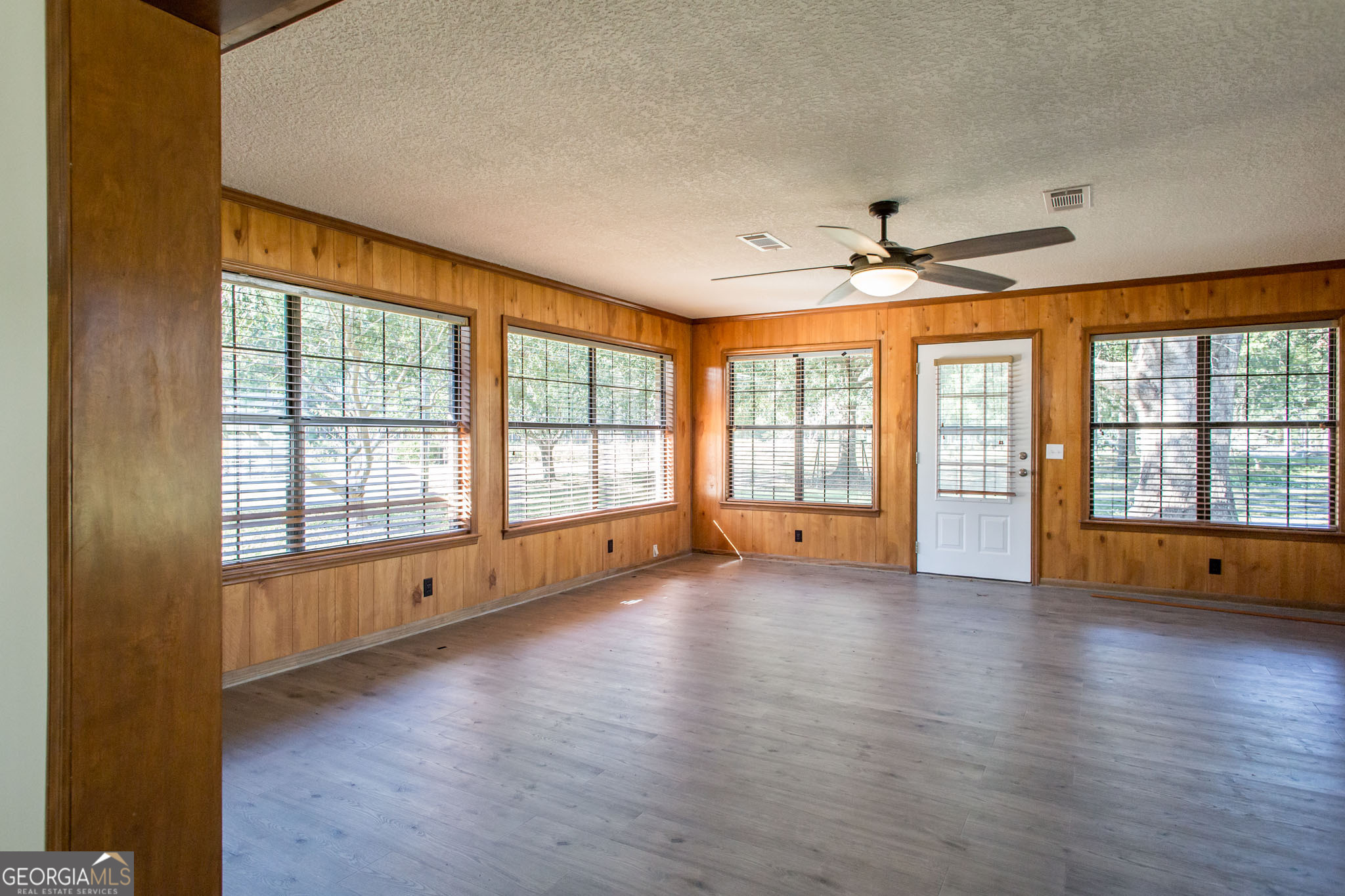 6731 Youmans Chapel Road Blackshear, GA 31516 - Photo 20 of 33 a view of an empty room with a window and wooden floor