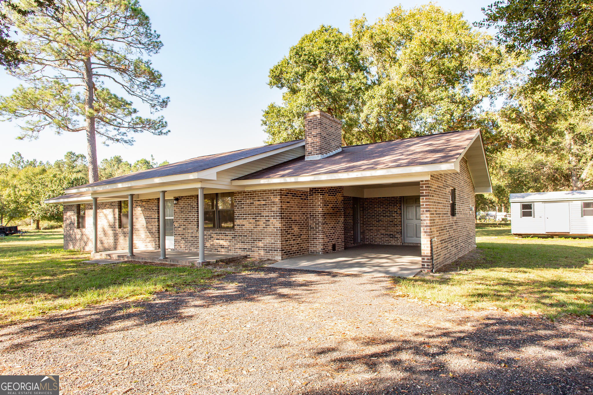 6731 Youmans Chapel Road Blackshear, GA 31516 - Photo 2 of 33 a front view of a house with a yard