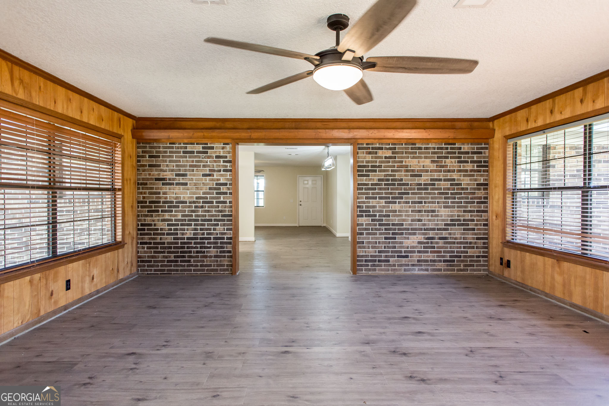 6731 Youmans Chapel Road Blackshear, GA 31516 - Photo 22 of 33 a view of an empty room with a window and wooden floor