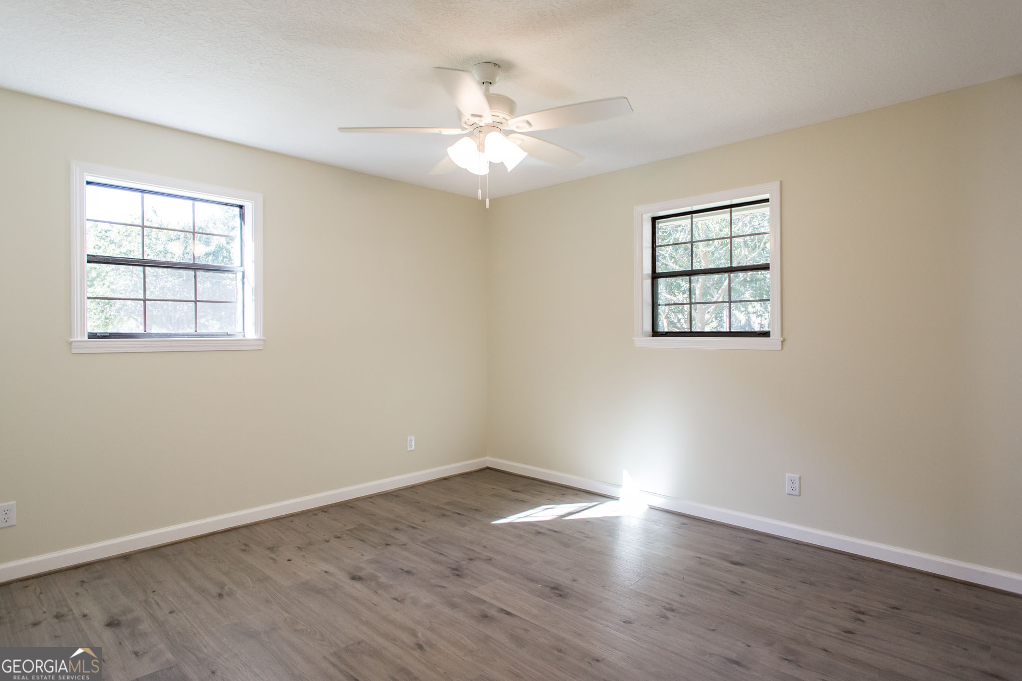 6731 Youmans Chapel Road Blackshear, GA 31516 - Photo 31 of 33 wooden floor in an empty room with a window
