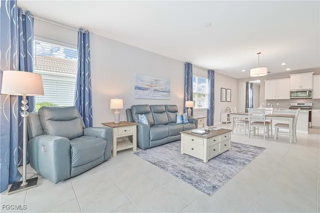 a living room with furniture and a lamp