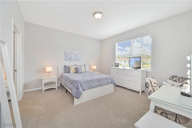 a bedroom with a bed and a chair in it