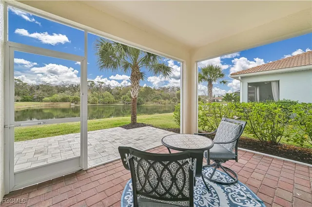 a view of a patio with a table chairs and a backyard
