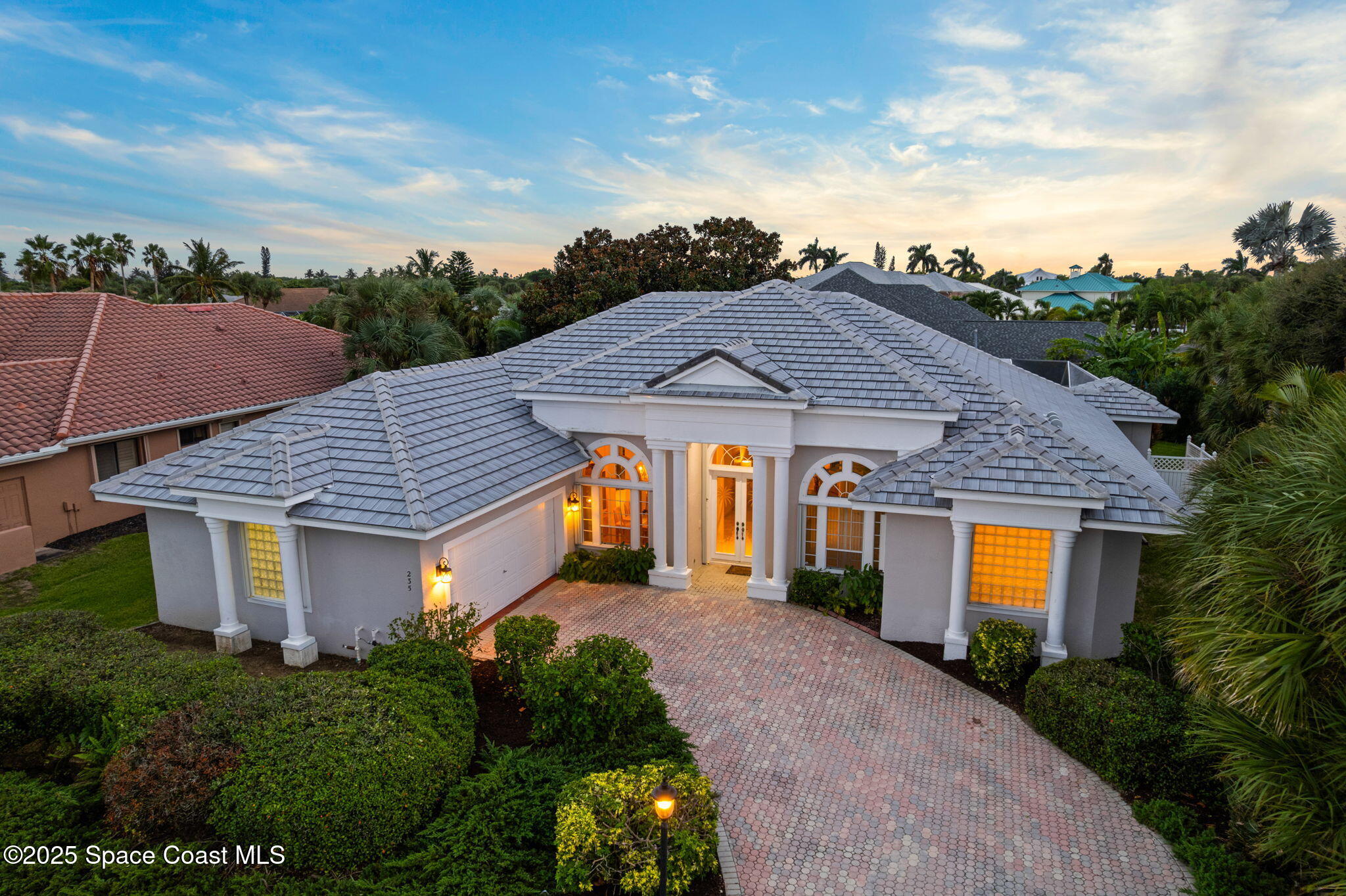 235 Loggerhead Drive Melbourne Beach, FL 32951 - Photo 1 of 50 a front view of a house with a yard and garage