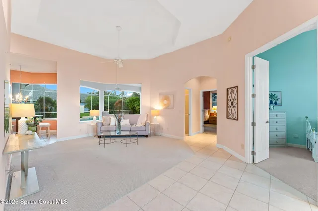 a living room with furniture and large windows