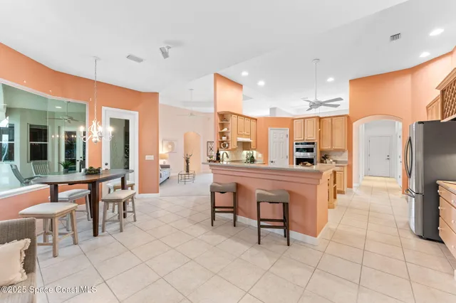 a large kitchen with a table and chairs