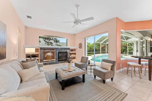 a living room with furniture large window and a fireplace
