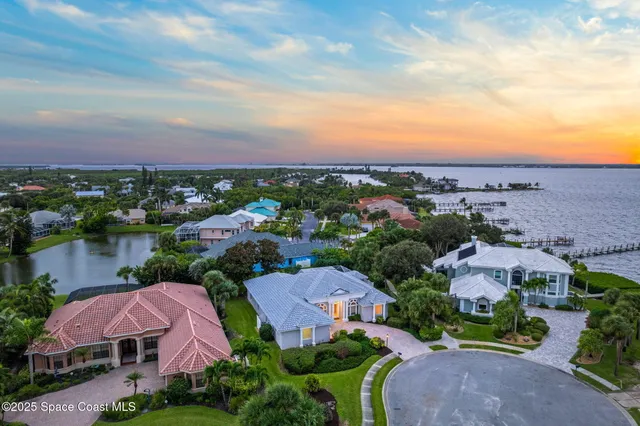 an aerial view of a houses with outdoor space and lake view