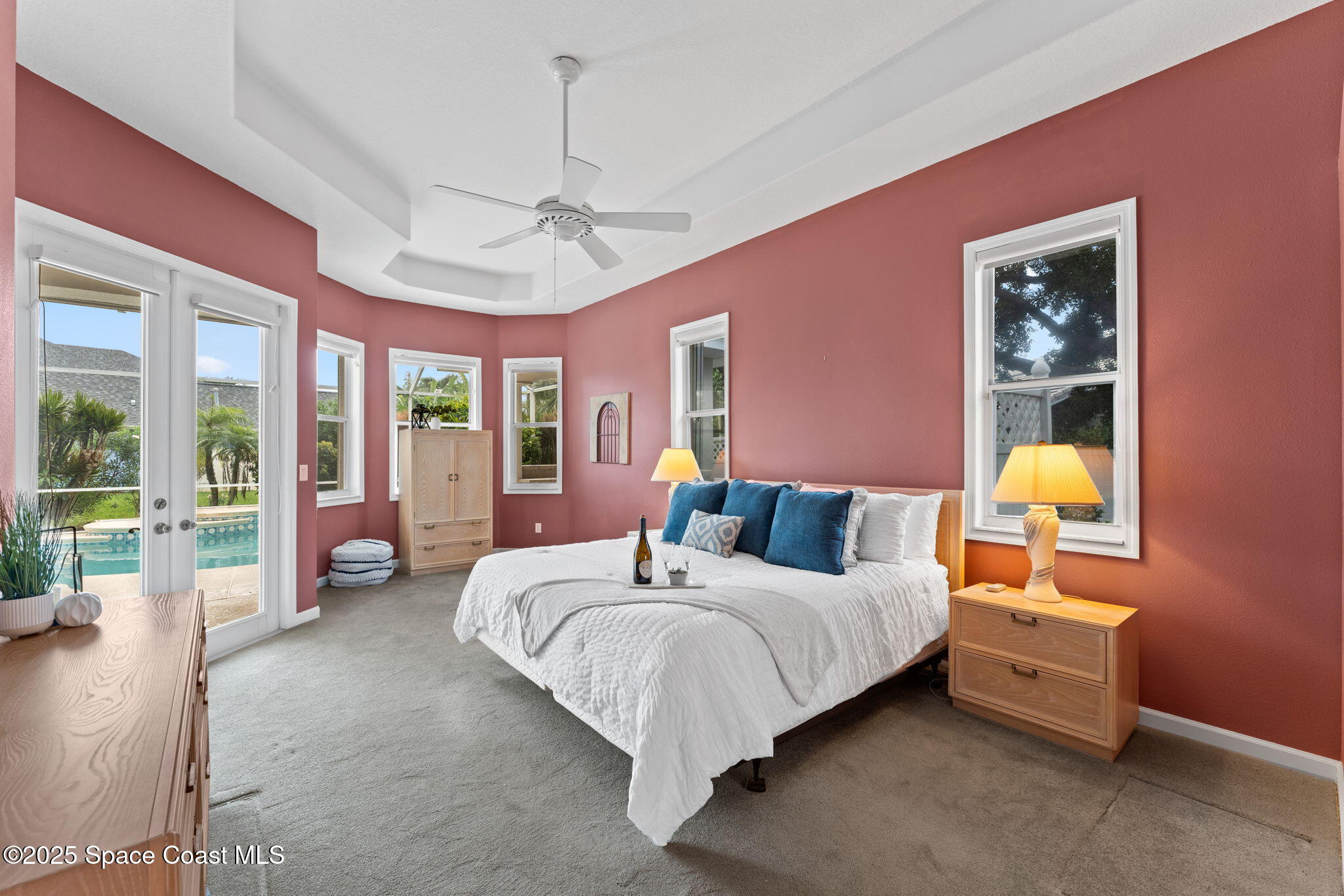 235 Loggerhead Drive Melbourne Beach, FL 32951 - Photo 23 of 50 a bedroom with a bed and a chandelier