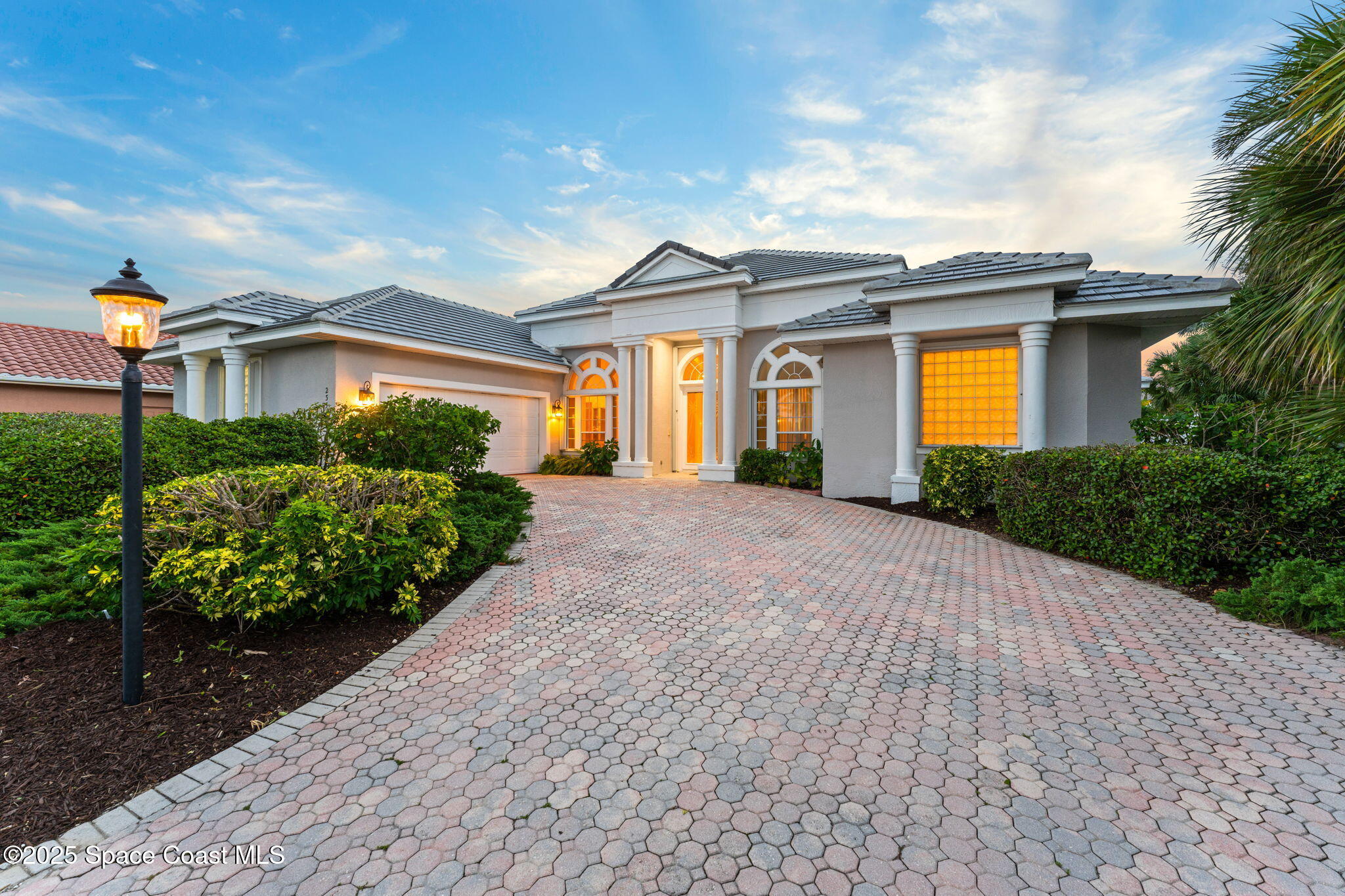 235 Loggerhead Drive Melbourne Beach, FL 32951 - Photo 3 of 50 a front view of a house with a yard and potted plants