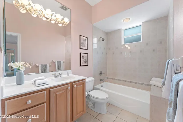a bathroom with a granite countertop sink a toilet and shower