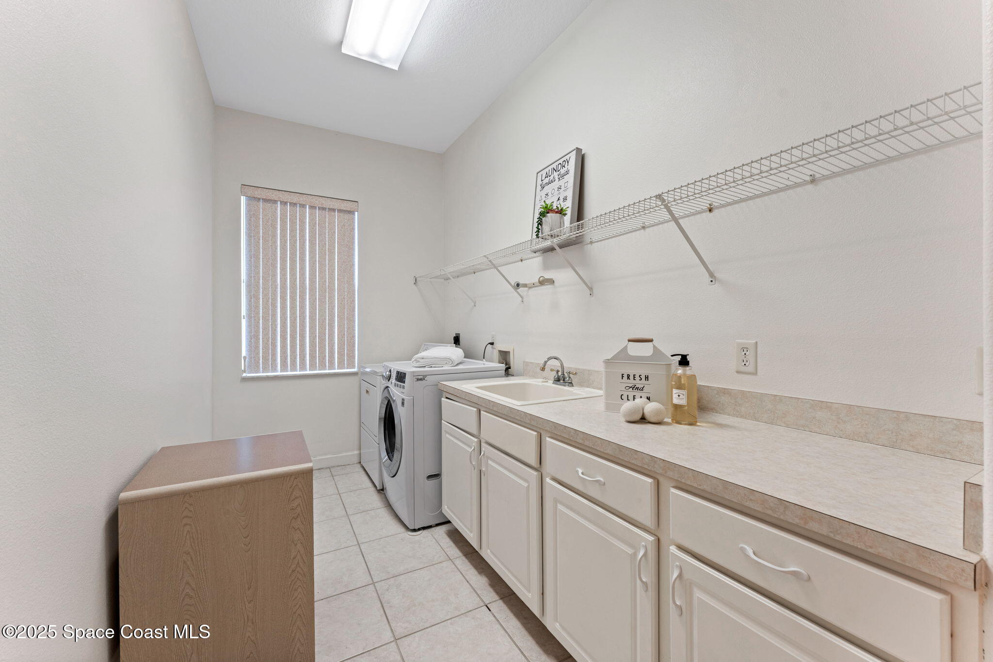 235 Loggerhead Drive Melbourne Beach, FL 32951 - Photo 32 of 50 a utility room with sink dryer and washer