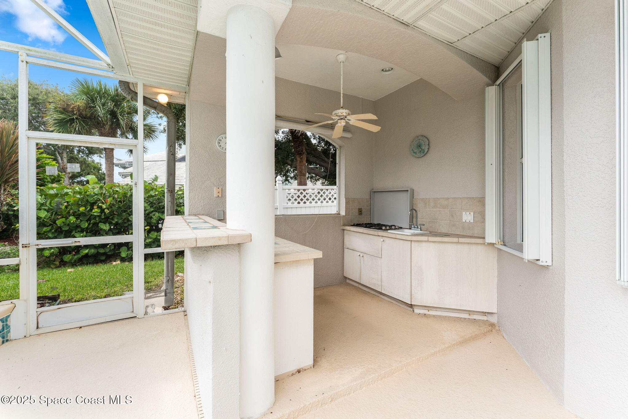 235 Loggerhead Drive Melbourne Beach, FL 32951 - Photo 35 of 50 a kitchen with a sink and a large window