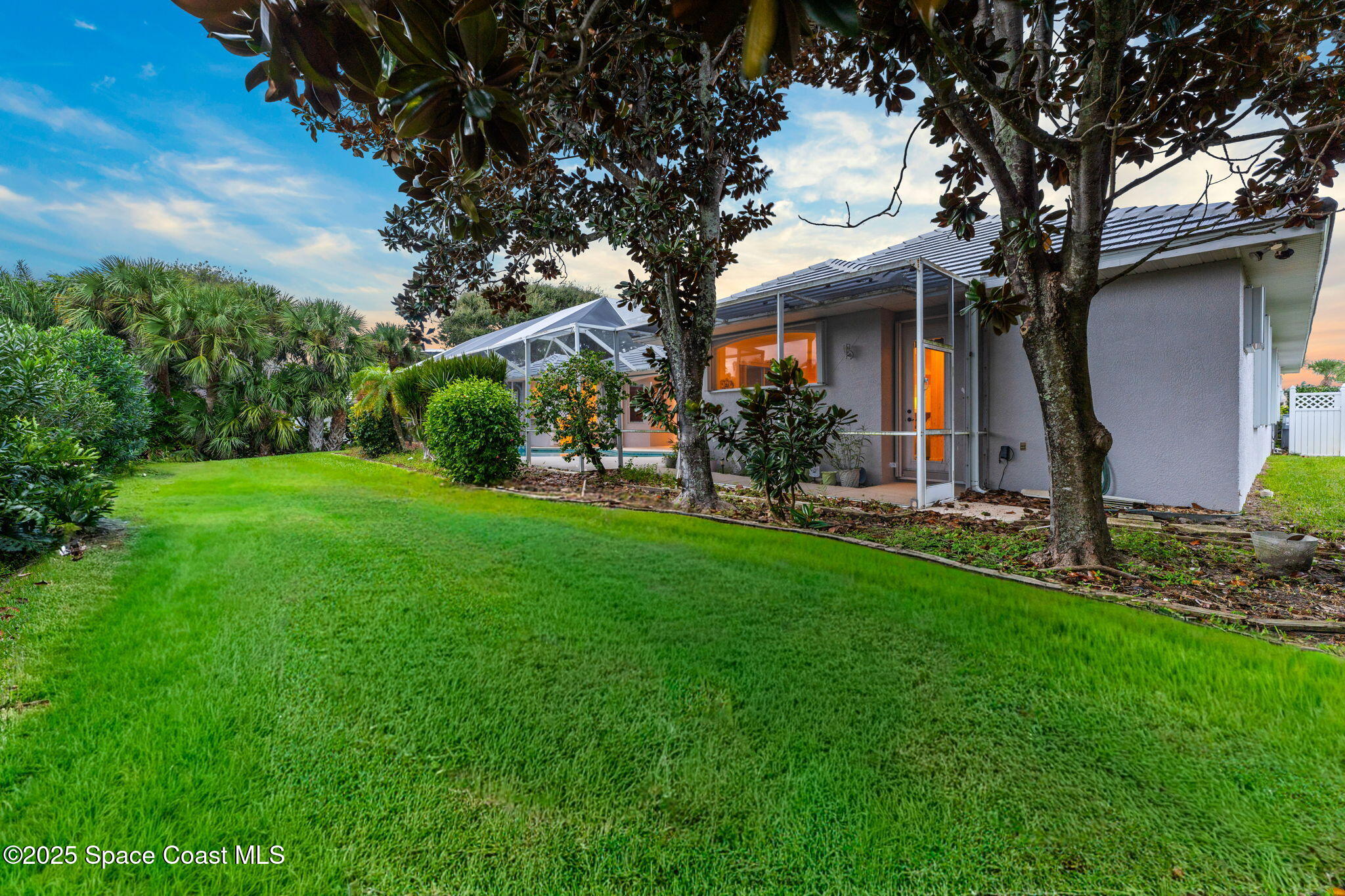 235 Loggerhead Drive Melbourne Beach, FL 32951 - Photo 39 of 50 a front view of a house with garden