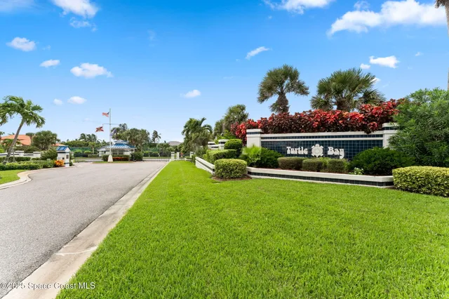 a view of a fountain in front of a house with a big yard