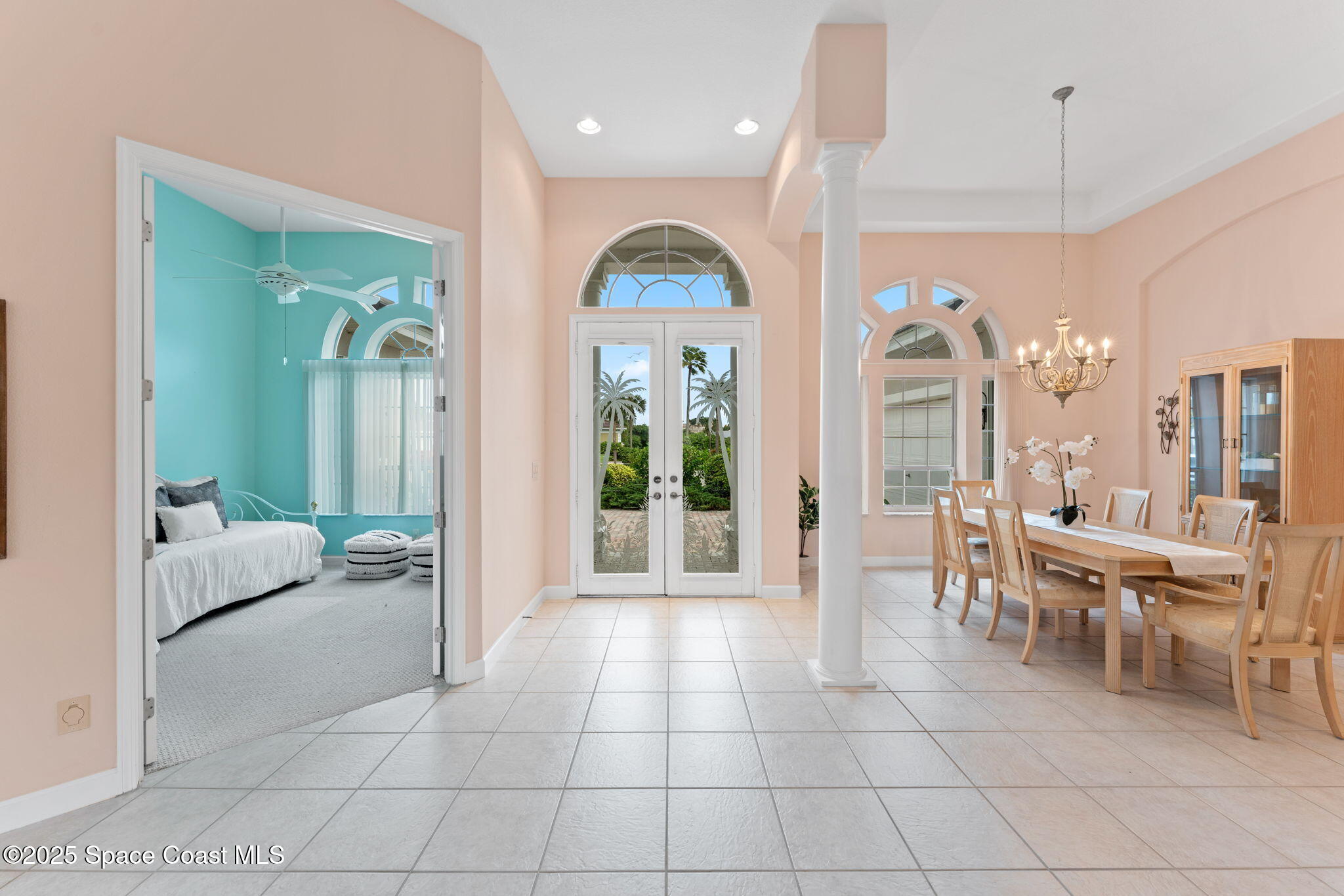 235 Loggerhead Drive Melbourne Beach, FL 32951 - Photo 7 of 50 a living room with furniture a chandelier and a large window